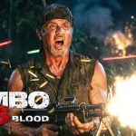 "Rambo 6 New Blood poster featuring Sylvester Stallone holding a machine gun with intense action scene, explosions and bullet casings"