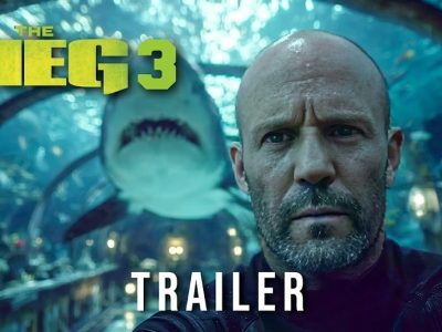 Official trailer thumbnail for The Meg 3 featuring a close-up of Jason Statham with a giant Megalodon shark behind him in an underwater tunnel.
