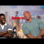 The Rock and Kevin Hart laughing together on a talk show set, showing their fun and friendly chemistry